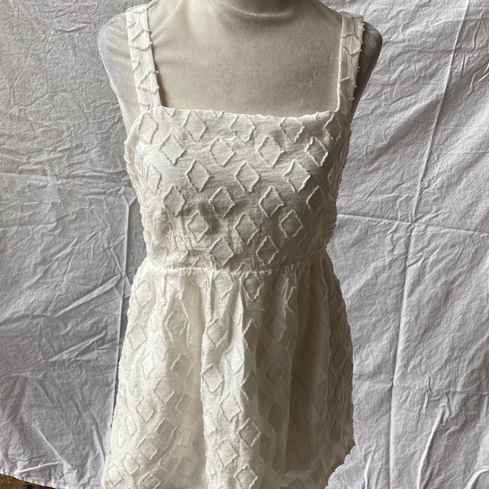 Anthropologie baby doll tank top with adjustable straps and elastic back.
